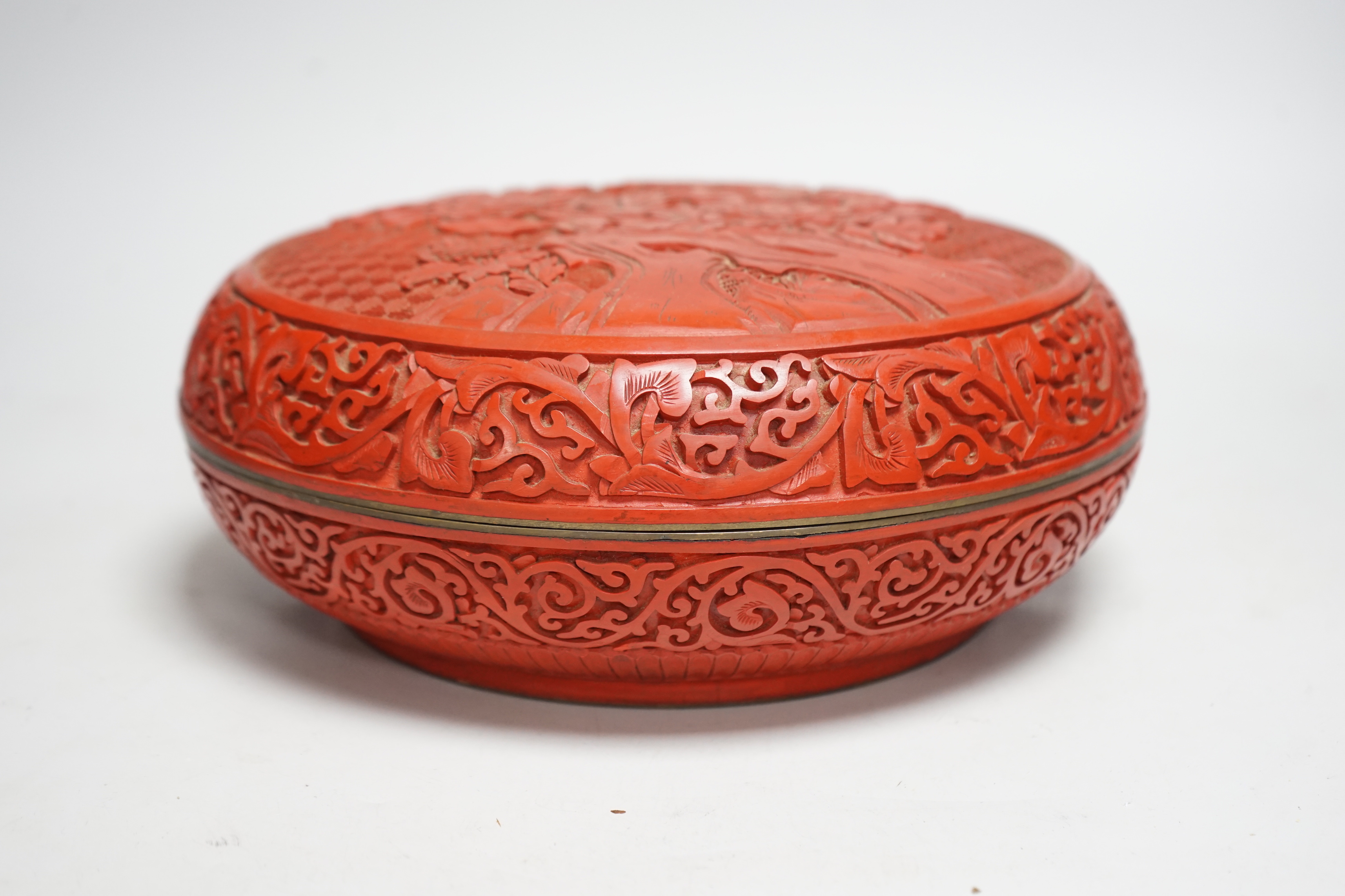 A 20th century Chinese cinnabar lacquer circular box, 25.5cm diameter